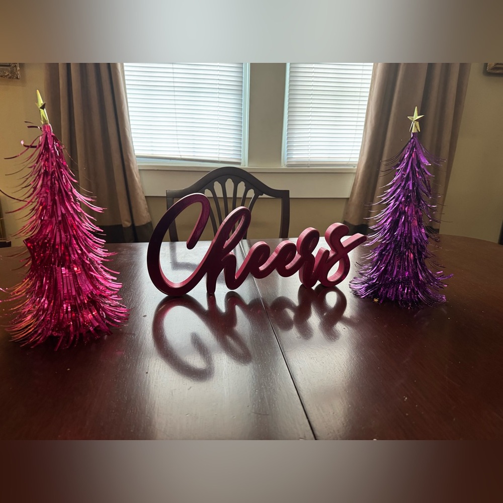 Vibrant Pink 'Cheers' Sign with Purple Tinsel Trees